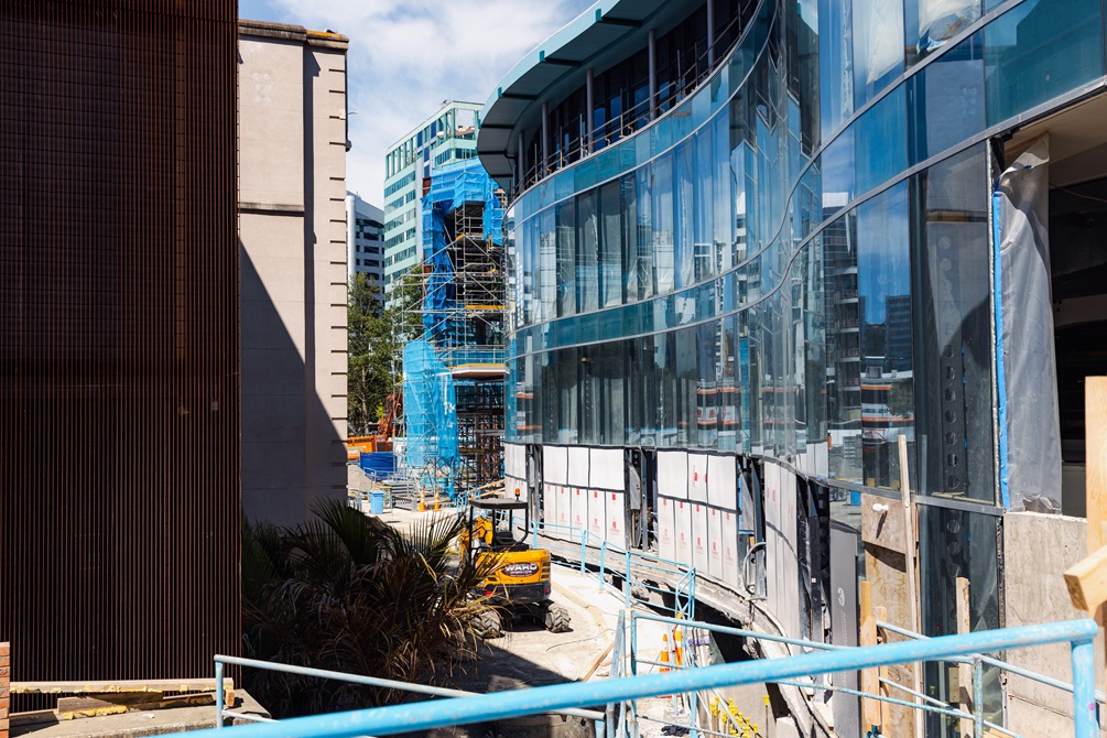 The exterior of a building under construction with wavy windows.