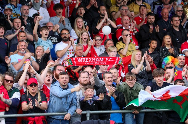 Wrexham fans watch match from stadium.