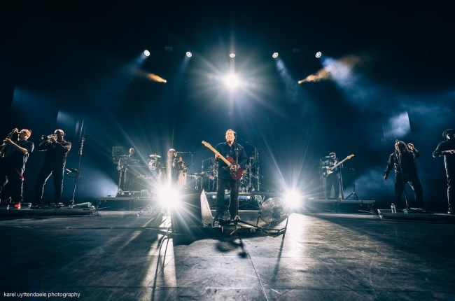 UB40 with Ali Campbell on stage performing.