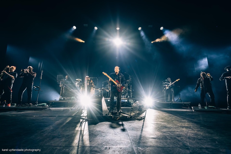 UB40 with Ali Campbell on stage performing.