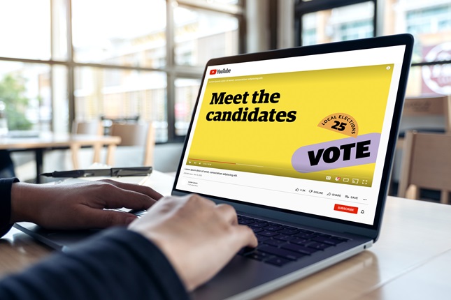 Meet the Candidates screen on laptop with hands on keyboard.
