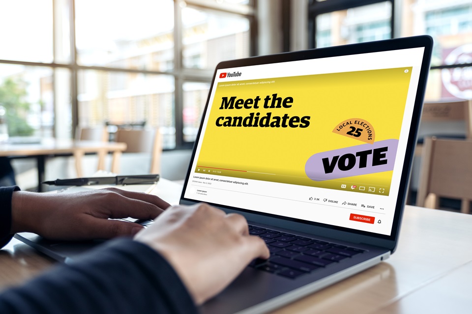 Meet the Candidates screen on laptop with hands on keyboard.