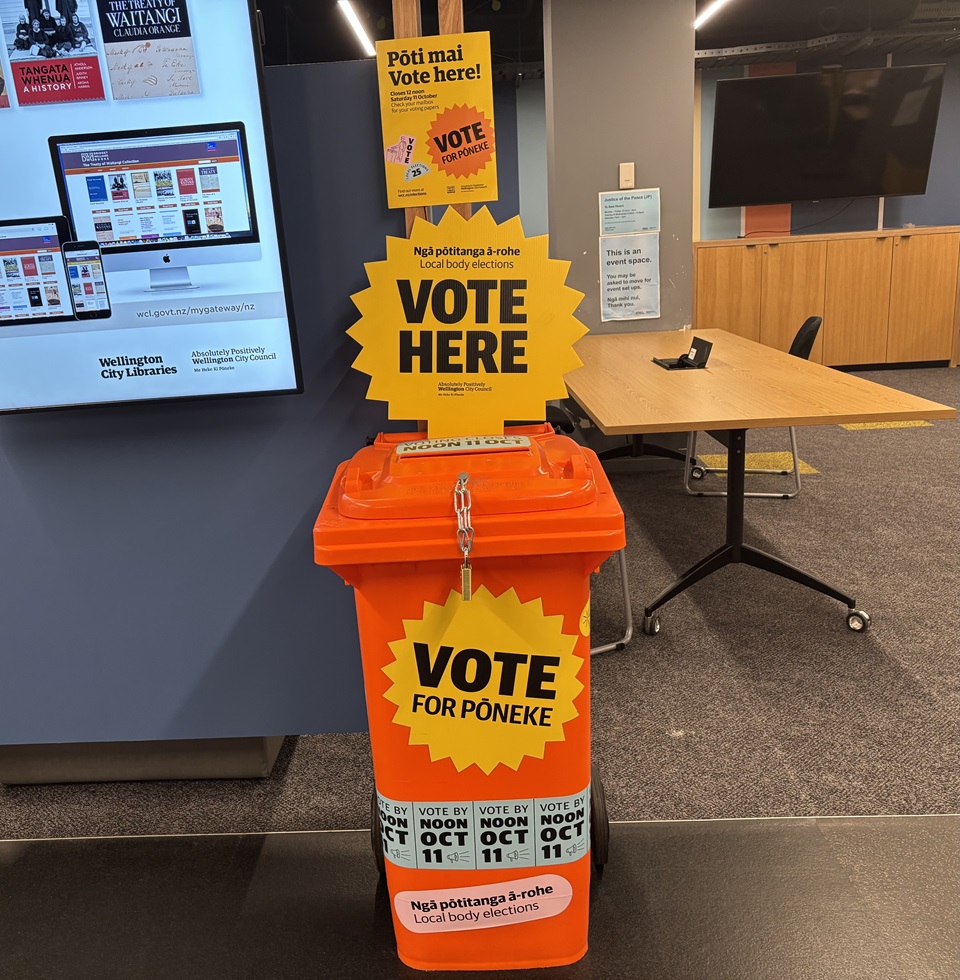 Orange bin placed in front of a wall 