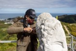 A photo of Ariki carving into the pouwhenua 