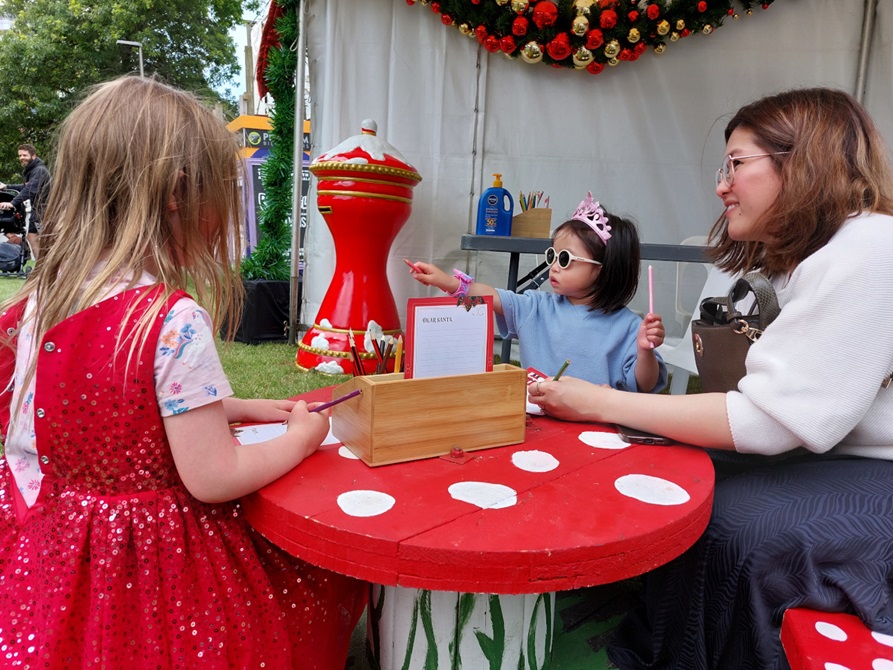 Children doing crafts at a Christmas event.