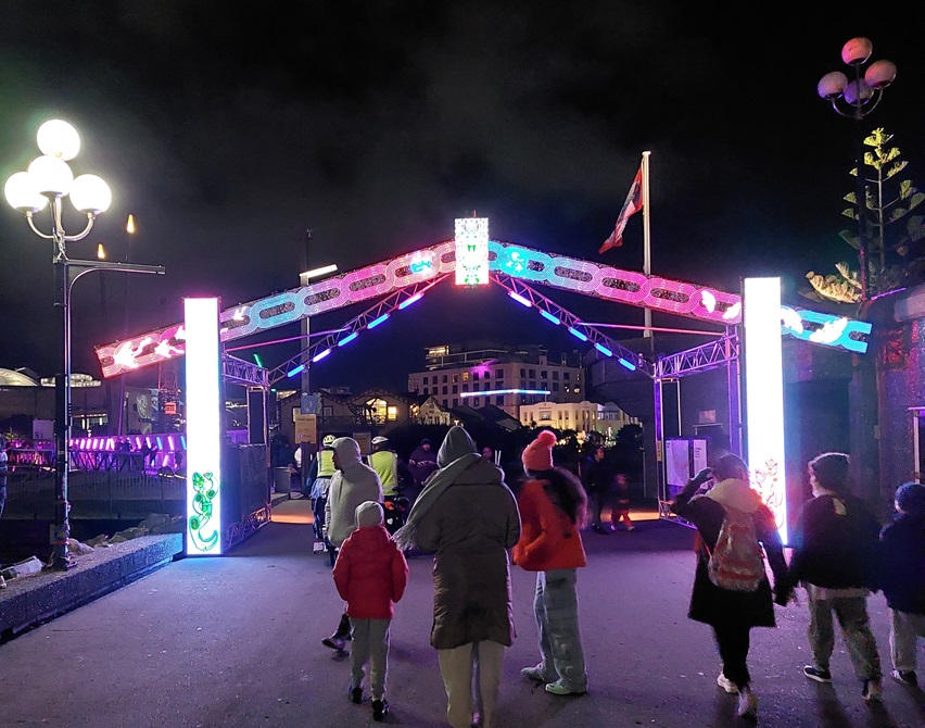 Ahi Kā attendees pass through an entry gate constructed of LED panels evoking Māori designs and motifs.