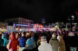 A crowd of people moving across the Wellington Waterfront.
