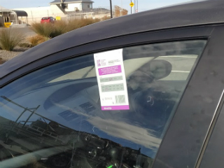 Coupon displayed in passenger side car window.