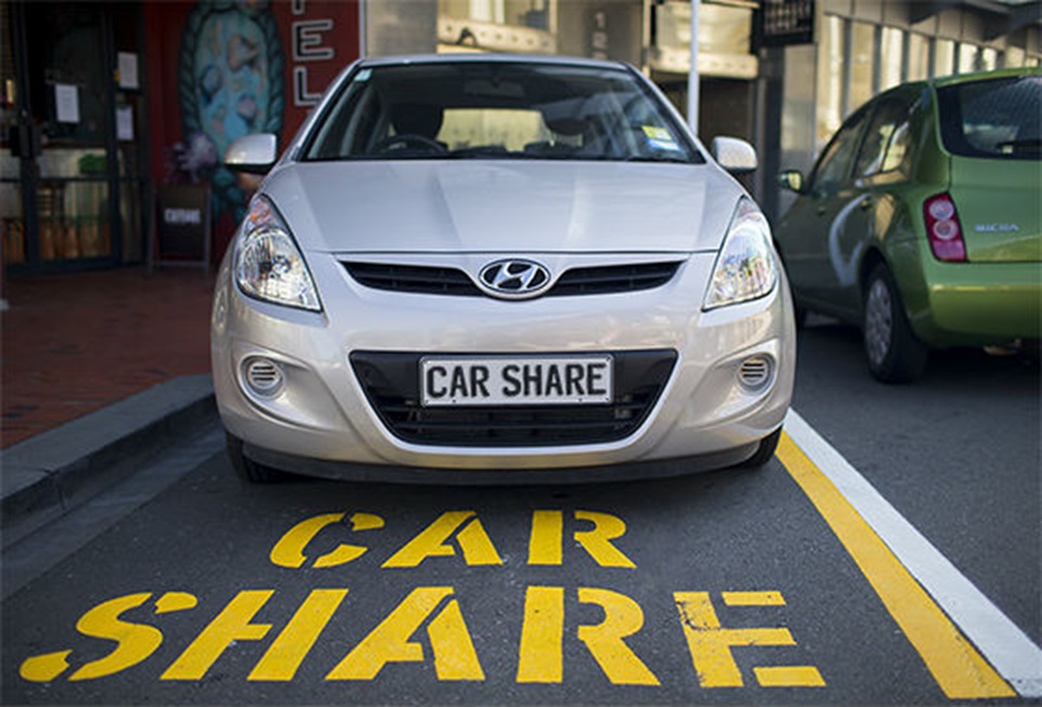 The photo shows a car share vehicle parked in a Wellington car parking space designated for car share vehicles. The word car share is painted on the road surface in large yellow letters.