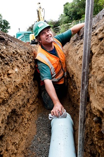 Man working in drain.