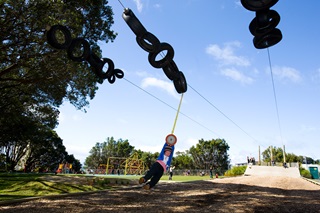 Children playing on flying fox at Central Park.