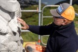 Matahi Brightwell working on the pouwhenua (land post) restoration.