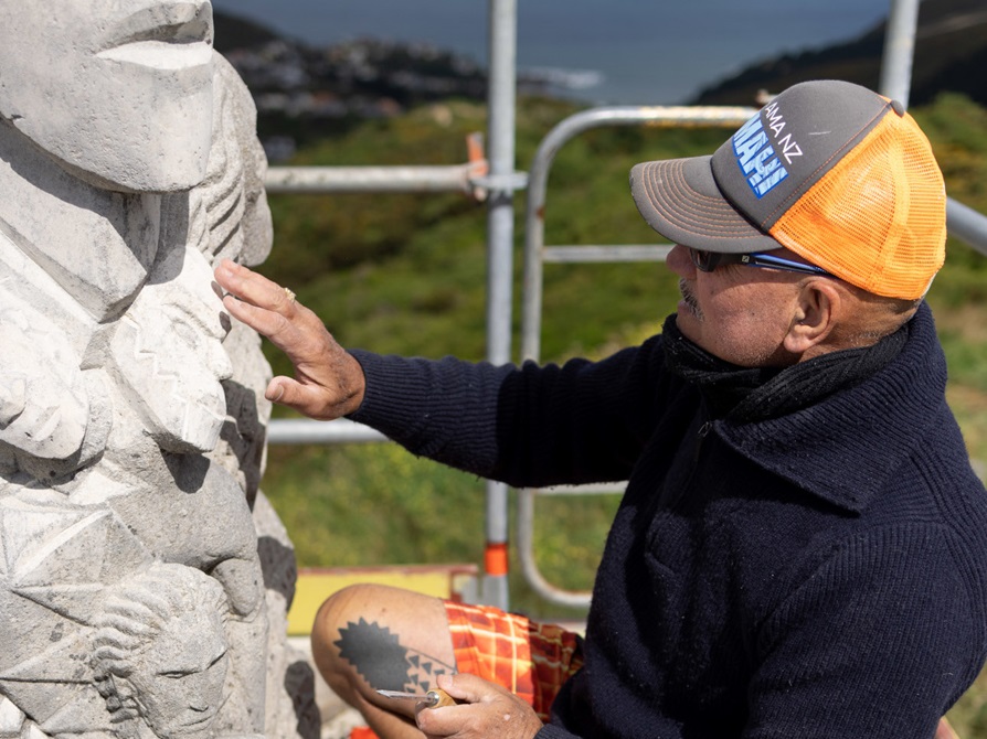 Matahi Brightwell working on the pouwhenua (land post) restoration.