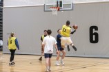 People playing basketball indoors.