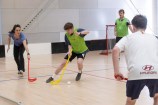 People playing hockey indoors.