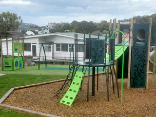 A play area with raised platforms reached by ropes, ladders, and climbing walls.