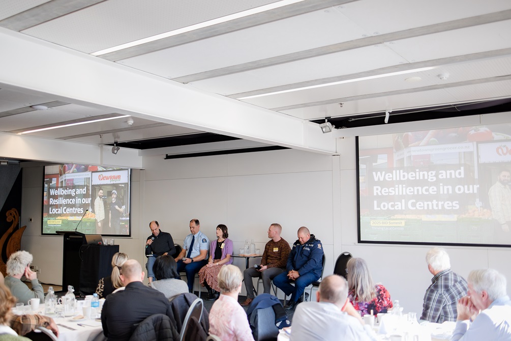 Panel members speaking at the BID summit 2025, including two police officers.