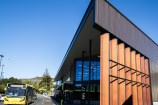 The outside of Waitohi Johnsonville community hub, and a bus sitting outside on the road.