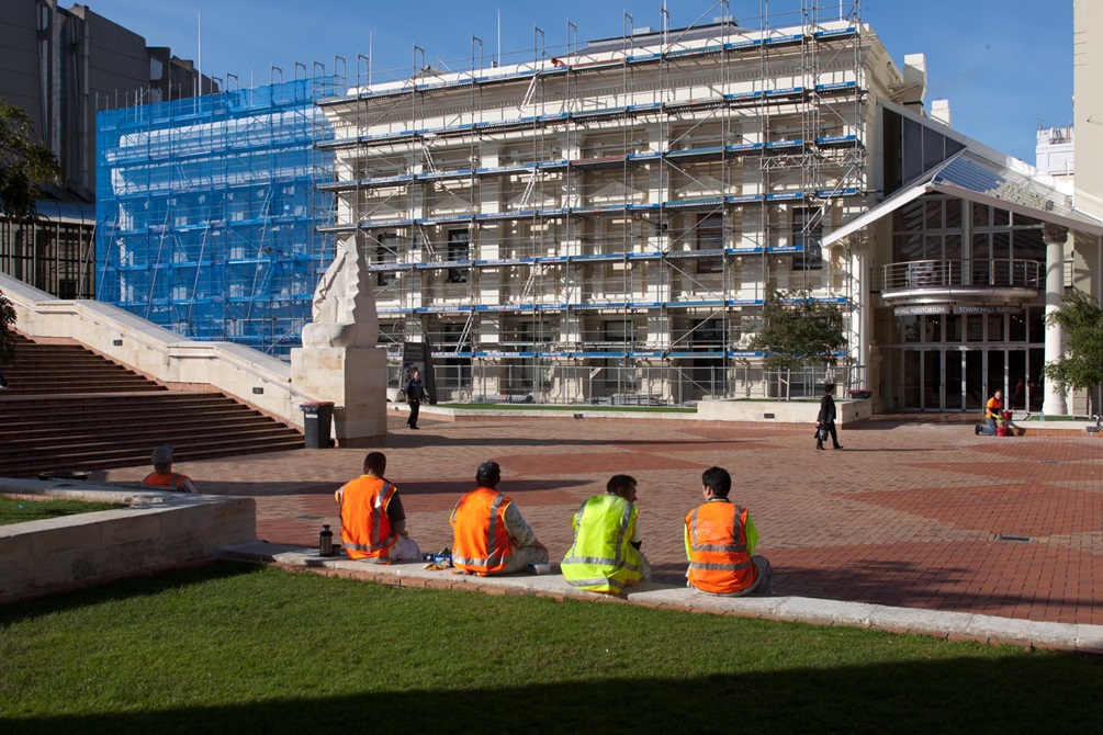 Workers take a break from painting the Town Hall.